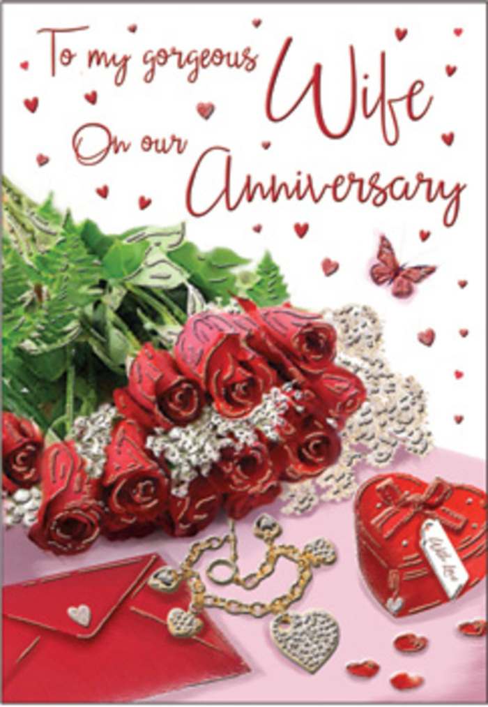 A sumptuously romantic anniversary tableau stretches across this card, reminiscent of a carefully styled still life in a Surrey home flooded with gentle afternoon light. At its centre, a bouquet of classic red roses takes pride of place, each bloom fully open yet perfectly formed, the petals folding and overlapping in rich tones of crimson and wine. The roses are wrapped and framed with lush green foliage, the varied shapes of the leaves adding texture and a sense of fresh abundance, as if freshly arranged by a florist in Cobham or Reigate. Surrounding the flowers are touches that speak of years of shared milestones: a beautifully finished jewellery set resting near the bouquet, catching glints of light along its contoured surfaces, and a vivid red box that hints at a heartfelt gift exchanged between partners. The card's elegant, cursive message sweeps across the design, accompanied by delicate heart motifs and lace-like patterns that draw the eye slowly from edge to edge. Scattered around the central composition, small trinkets and shimmering accents lie like cherished mementos, while the suggestion of a butterfly adds a gentle sense of motion and whimsy. Textures interplay across the image-soft, satin-like petals, cool metal jewellery, crisp paper, and perhaps a hint of velvet or silk in the background-combining to evoke warmth and intimacy. The entire scene conveys the feeling of an anniversary celebrated in Surrey, where quiet evenings, familiar landscapes, and the comfort of shared history all come together, much like these roses, to form a lasting, deeply affectionate embrace captured in floral form.